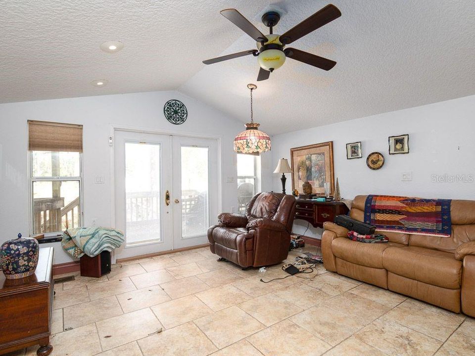 25925 Blue Lakes Dr, Paisley, FL 32767. Great Room with French doors leading to back deck.