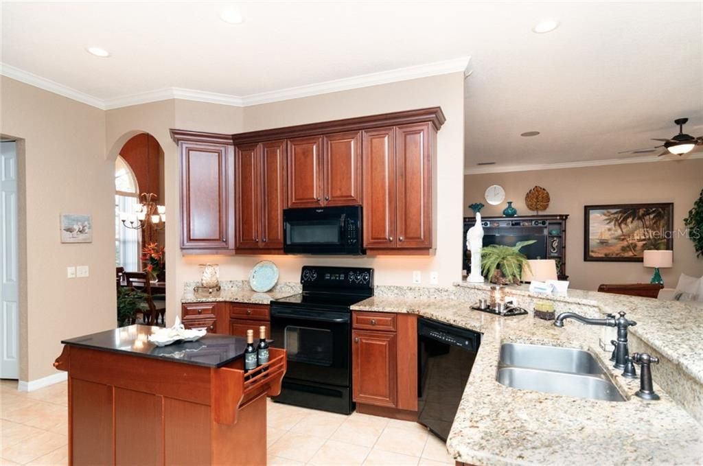 Kitchen with cherry cabinets, granite counters and upgraded appliances.