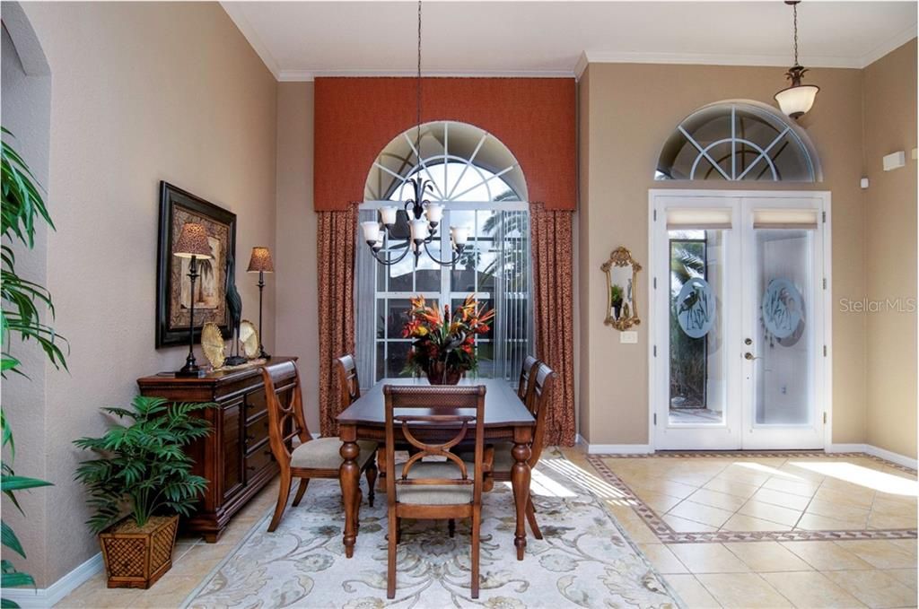 Lovely look at the dining room with the large window in the rear and the front door on the right.