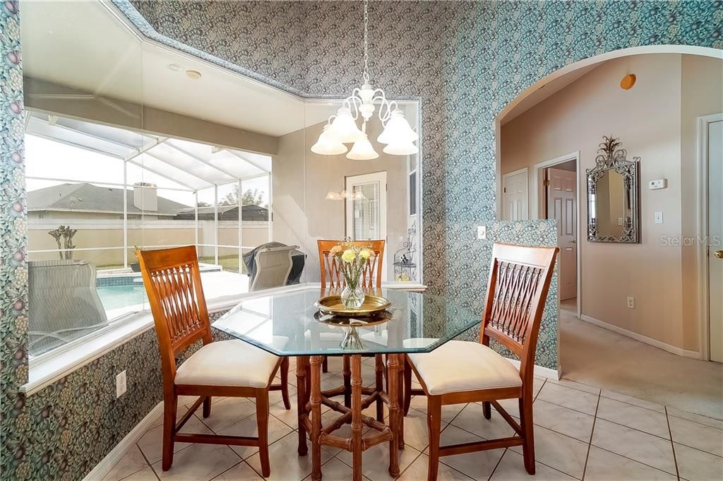 Enjoy meals in the dinette space with a bay window providing ideal views of the pool with a freshly painted pool deck.