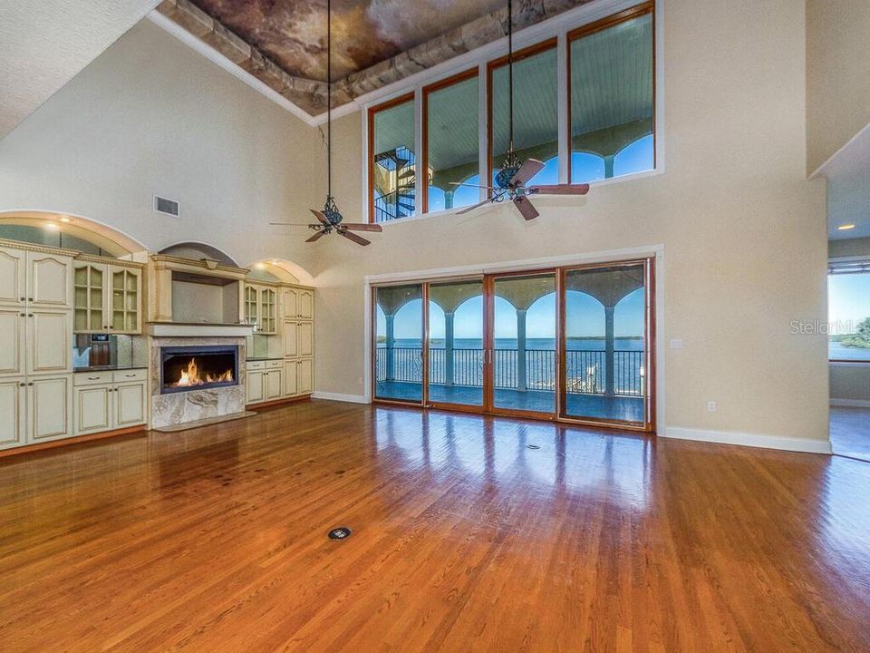 GREAT ROOM WITH SCENIC WATERVIEWS,BUILT IN AREA W/GAS FIREPLACE AND SOARING FAUX PAINTED CEILINGS