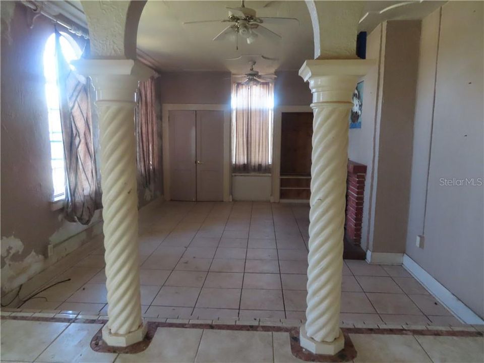 Large Tile Living room with Columns ,Bench seats and FIREPLACE