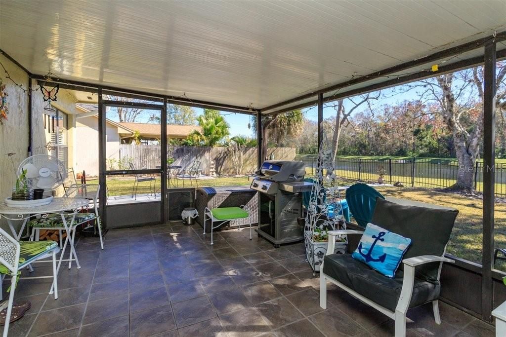 screened in patio with great view of back yard and water