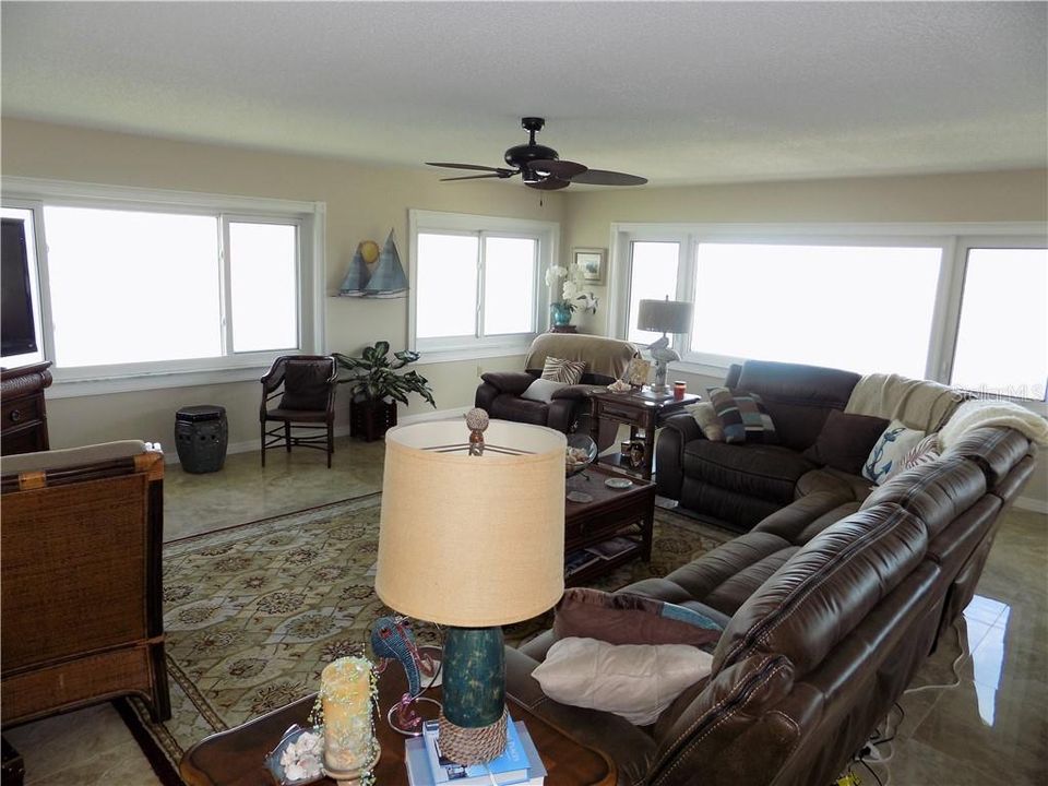 SPACIOUS FAMILY ROOM WITH WRAP AROUND WINDOWS OFFERING FULL WESTERLY AND NORTH WEST WATERVIEWS