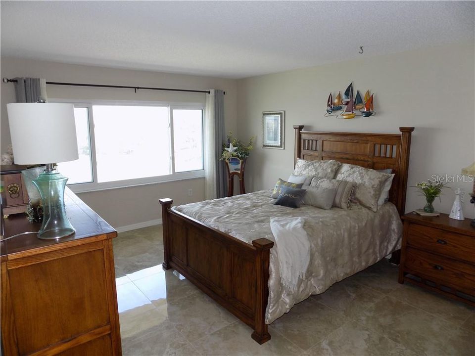 SECOND BEDROOM SUITE FEATURES GORGEOUS FULL WEST AND NORTHWEST WATERVIEWS,PRIVATE UPDATED SECOND BATH AND A WALK IN CLOSET