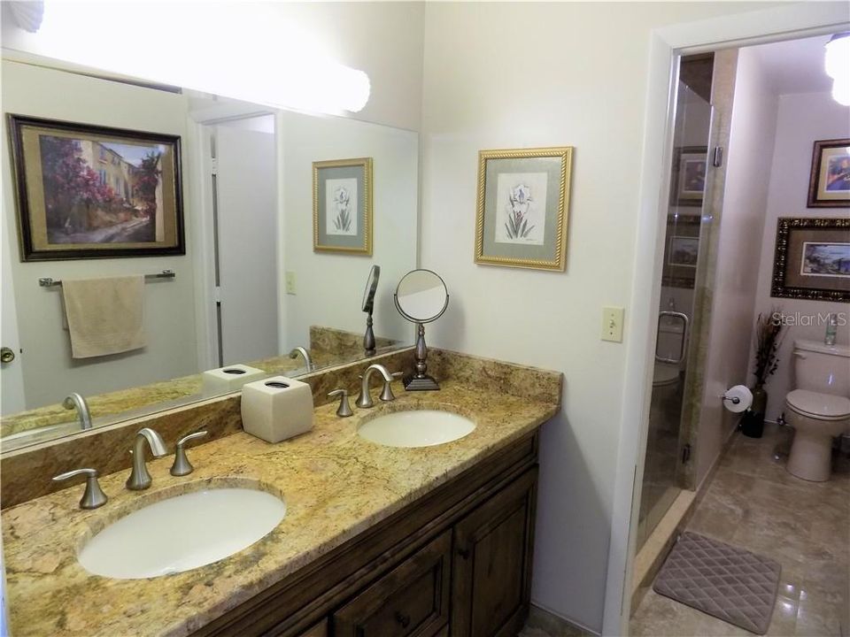 MASTER BATH WITH UPDATED CABINETRY,GRANITE COUNTERTOPS AND FRAMLESS GLASS ENCLOSED WALK IN SHOWER
