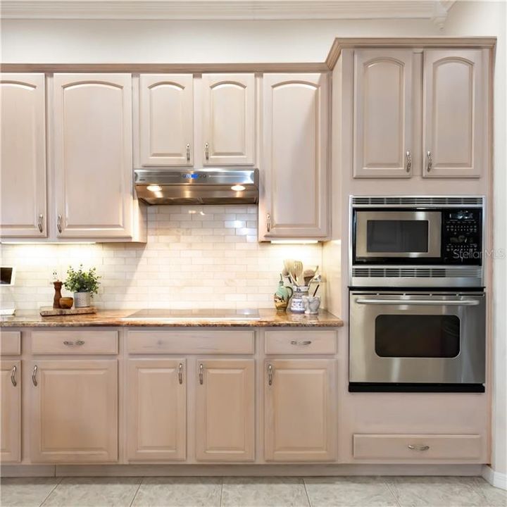 Italian marble backsplash, Stainless Broan exhaust fan, Bosch cooktop, 42" Maple cabinets with Crown & built-in ovens!