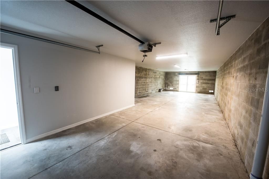 Garage is 46 feet in length with a storage room, Liftmaster garage opener, Ring Doorbell at entrance, sliders to the backyard deck. All Marine switches on this level!