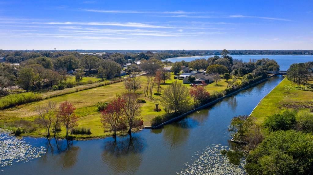 Canal on west side of property connects Lake Shipp (at upper end) down to Lake May. Both lakes are part of Winter Haven's chain of lakes. This property has its own private boat ramp leading into the canal.