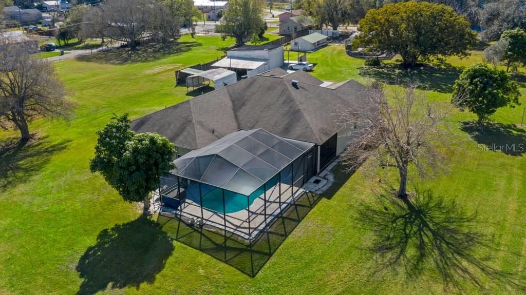 Property includes the primary residence in foreground featuring in ground saltwater pool in the screened lanai, and various ancillary buildings perfect for parking RV's, boats, long bed trucks, mowers, 4-wheelers, etc. NO HOA!!!