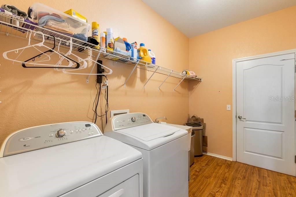 Inside Laundry Room with laundry sink off kitchen.  Door leads to garage.
