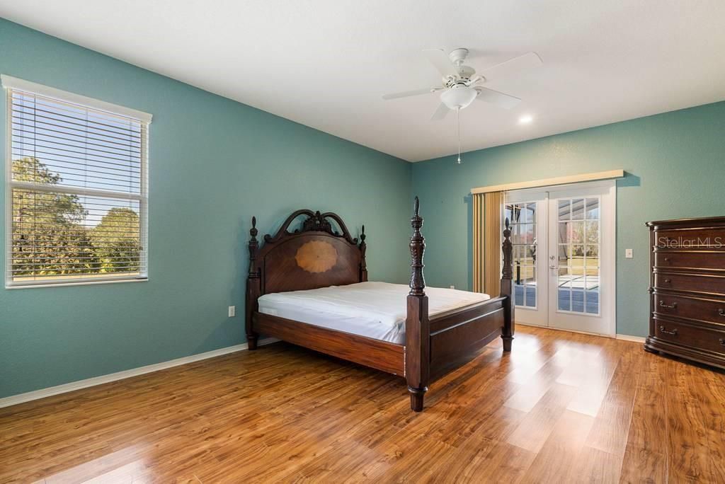 Master Bedroom with window view to Canal and French Doors leading to Pool Lanai