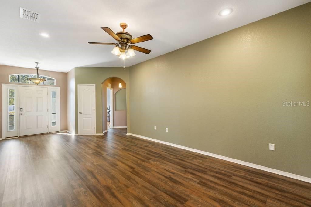 Entry and Formal Living Room; arched doorway leads to private office/den/study and to Master Bedroom and Bathroom Suite.