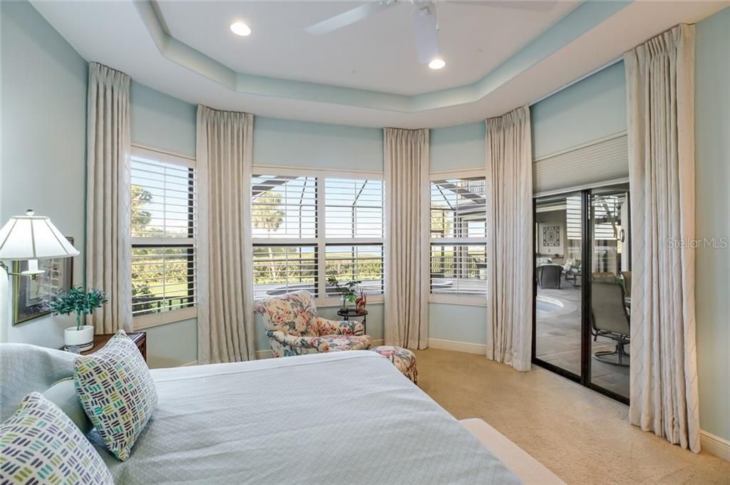 Master bedroom with sliders and view to the pool.