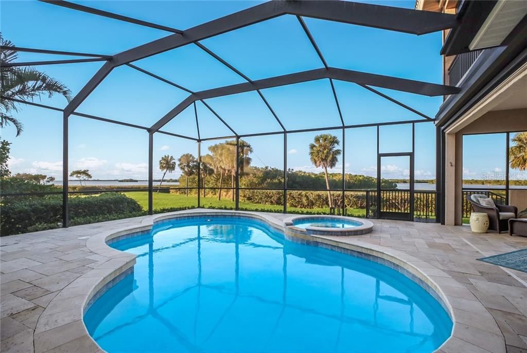 Pool area with travertine deck overlooking the bay.