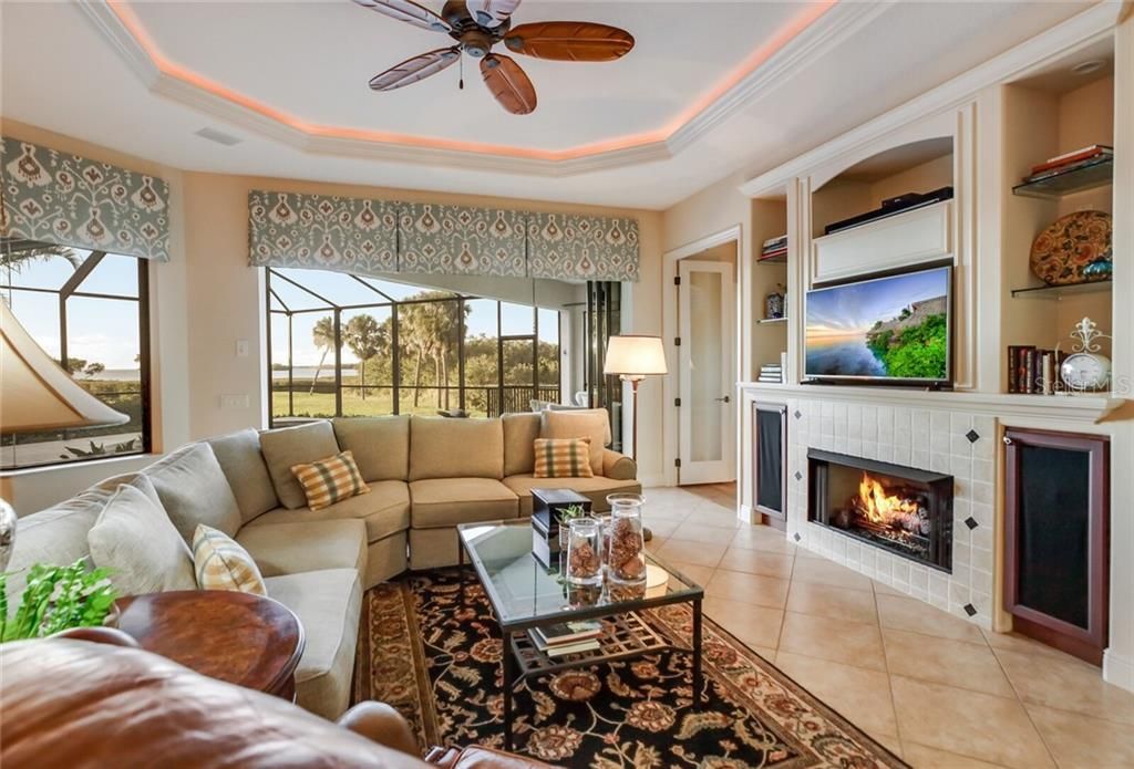 Family room with gas fireplace, sliders leading to the pool.