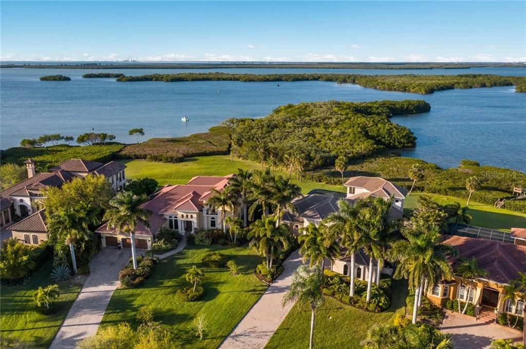 Aerial views of home with water views.