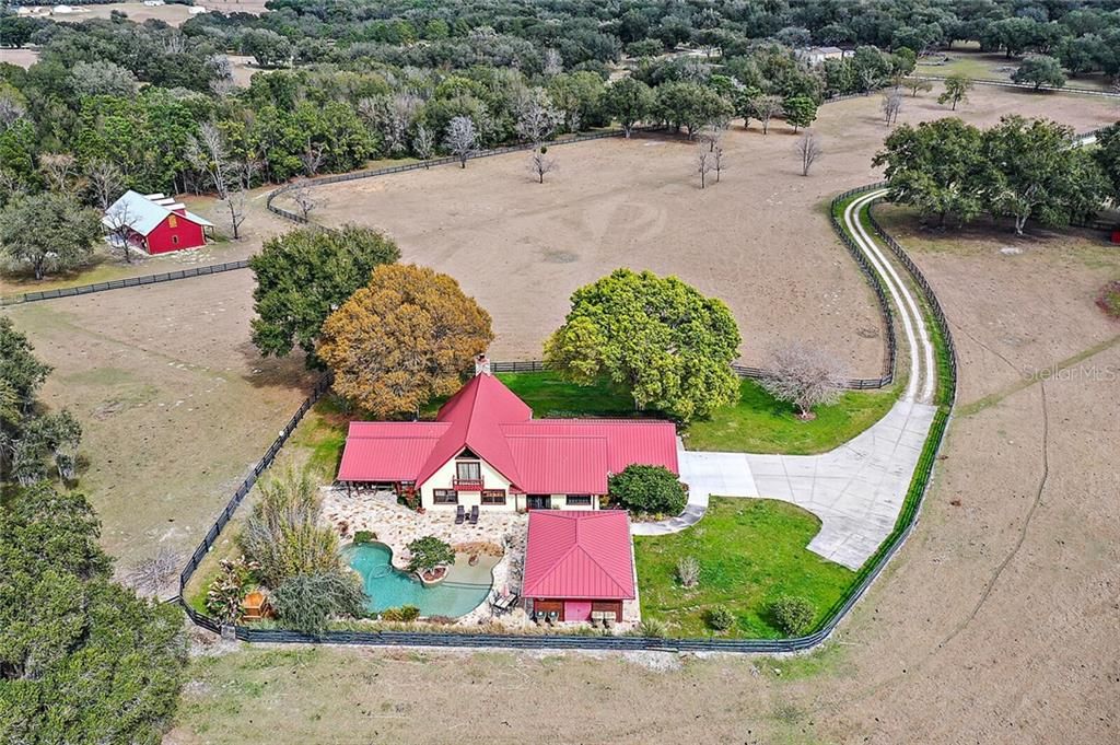 Aerial of Home, Pool and Adjacent 6.3 Acres with Unfinished House Available for Sale at $290,000