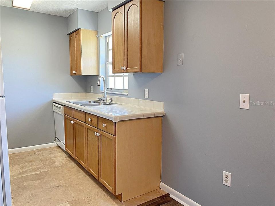 The kitchen offers a window to the large backyard