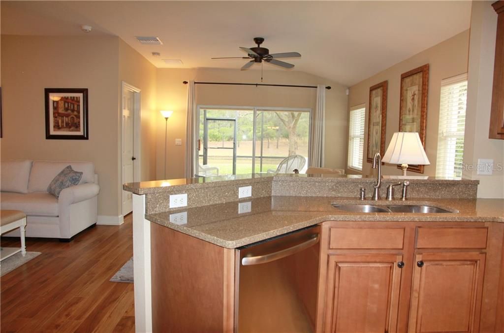 Open floor plan with view of pond from kitchen-dining and living.