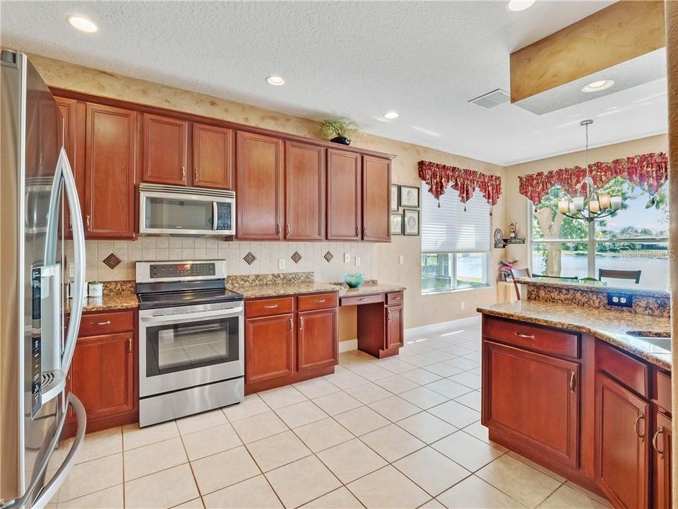 Big Kitchen with plenty of 42" solid wood cabinets, granite counters, stainless steel appliance - and pretty outdoor views