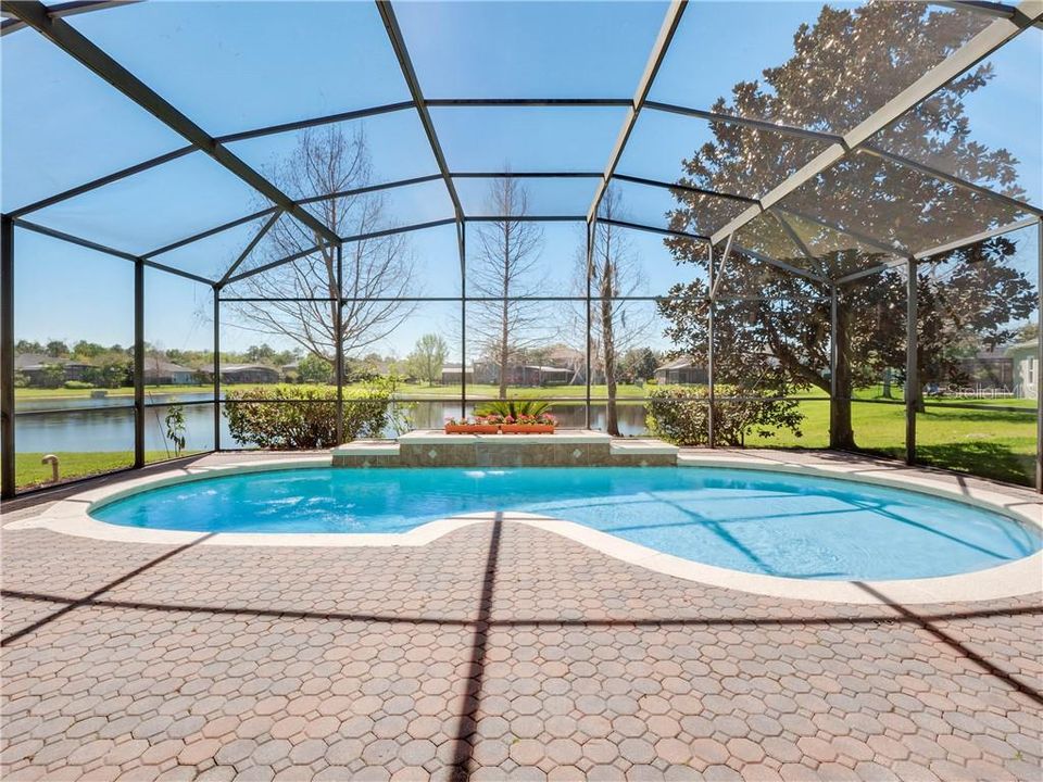 Screen enclosed pool overlooking pond