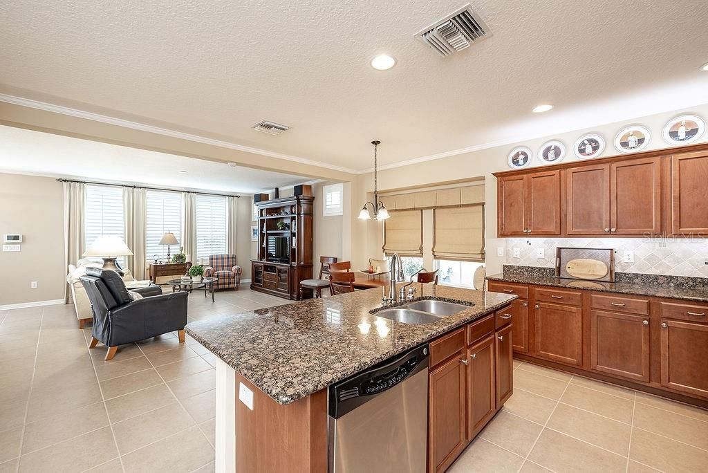 Kitchen and family room with lovely tile flooring.