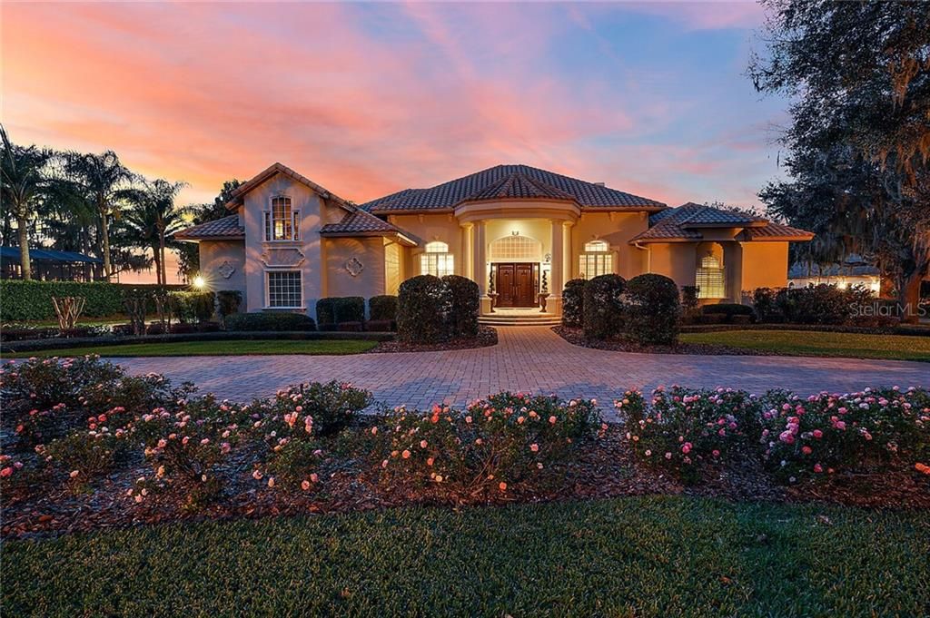 Lake Harris-Chain of Lakes custom estate pool home with boathouse on 1 acre in private gated community