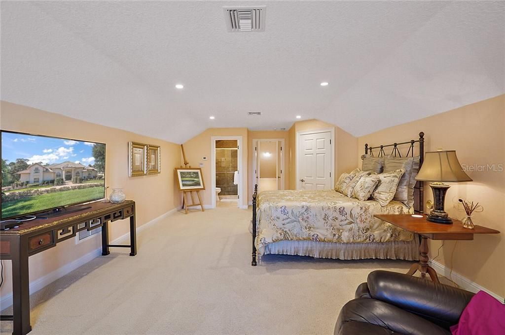 This spacious room offers a walk-in closet and a beautiful full bathroom with a Travertine shower.