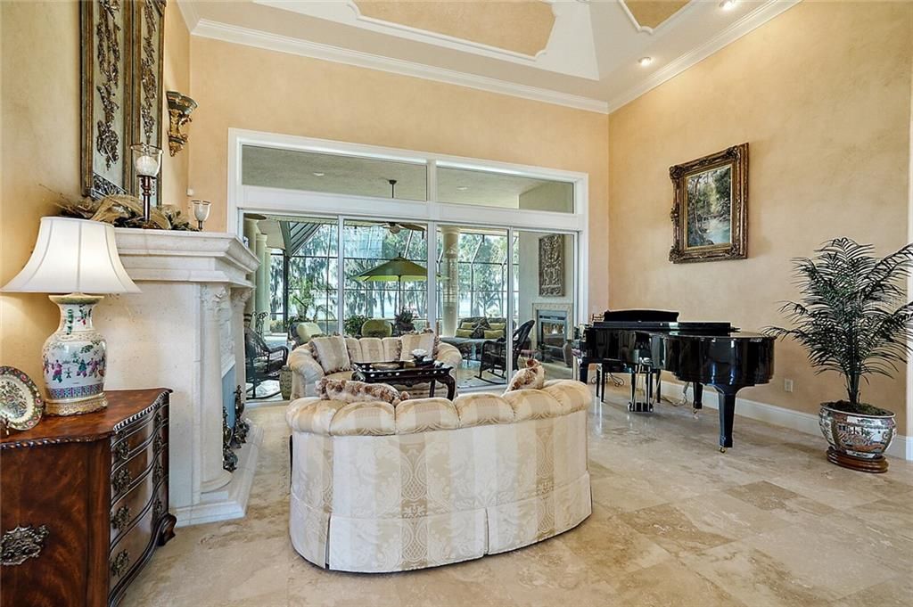 The living room has a gorgeous stone gas fireplace and telescoping glass doors to the pool lanai.