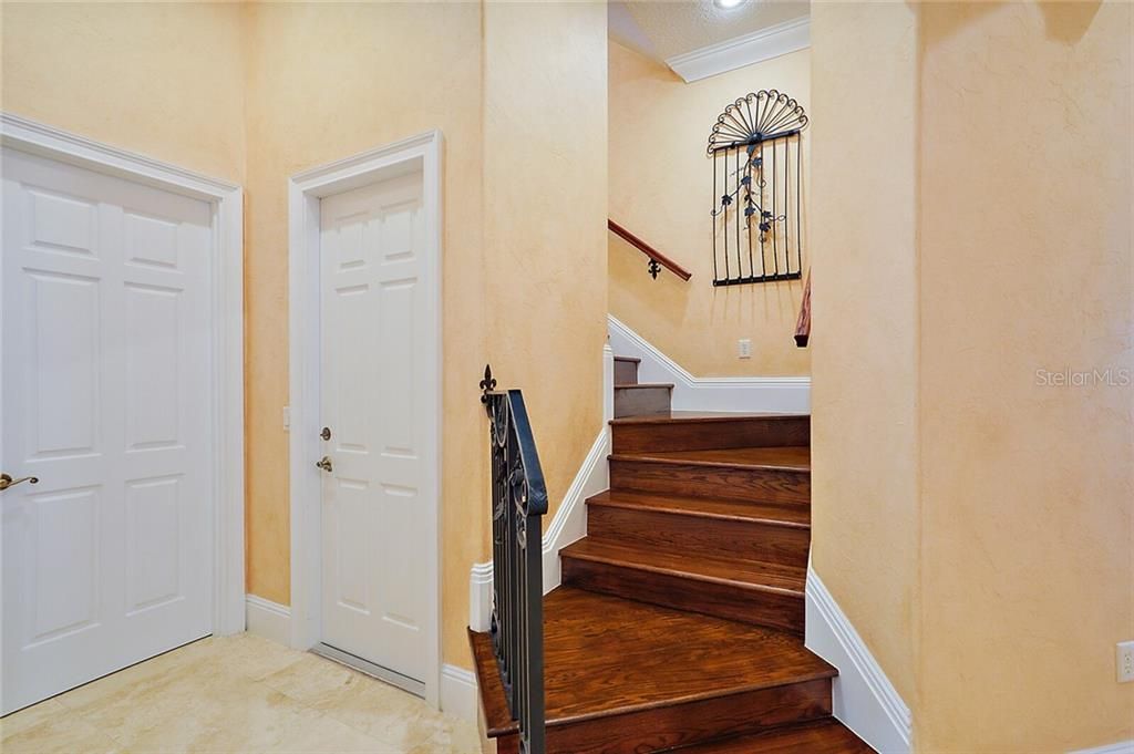 Custom iron stair-railing leads to the upstairs bedroom or bonus room.