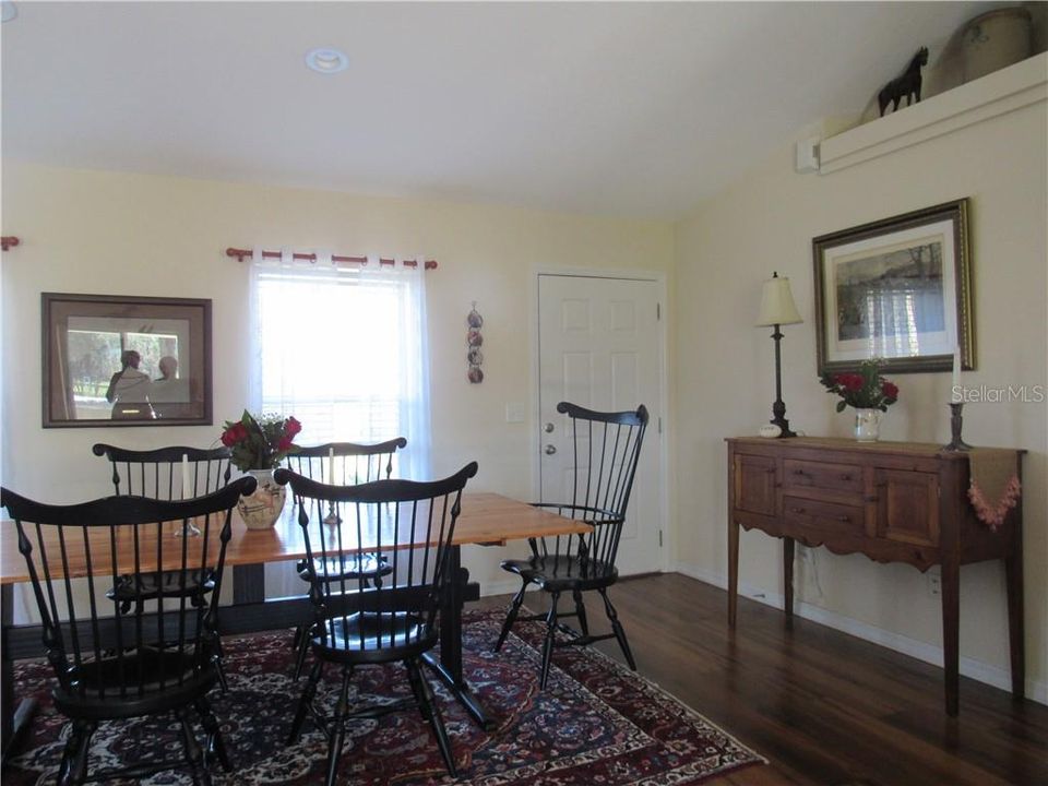 The front door enters into the large dining area.  Wood laminate throughout gives a bit of the old farmhouse feel.