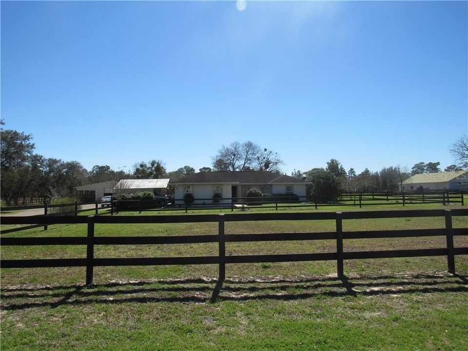 Beautiful ranch home from the road looking in.  Get that country feel with the peace and quiet; only birds chirping with an occasional "whinny".  Gotta love it!