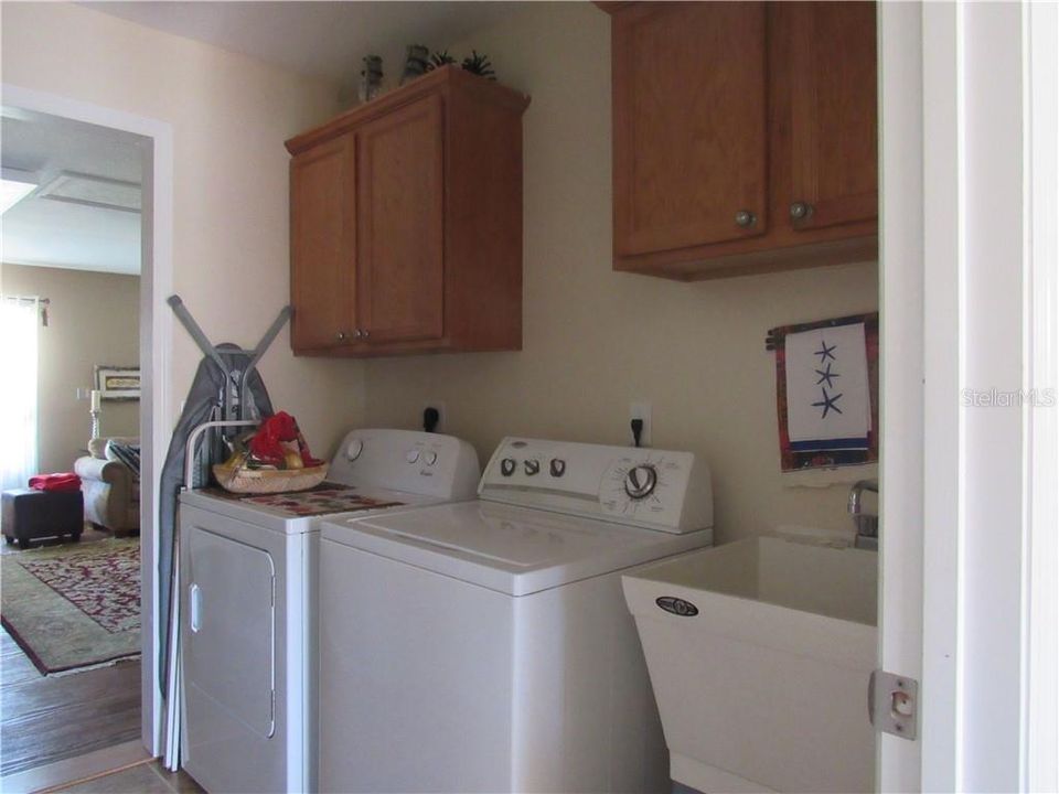 The inside laundry room is nicely placed in the home in the middle of everything you do.