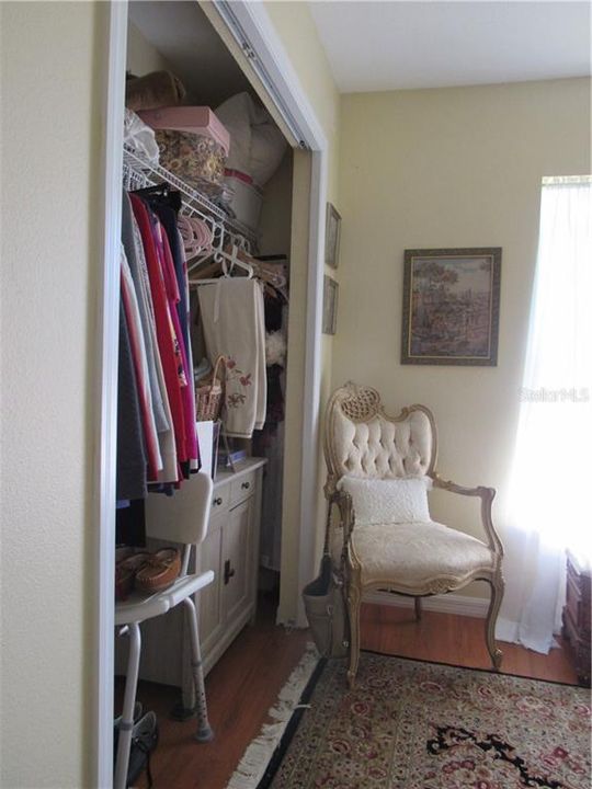 The full wall closet has lots of storage area.