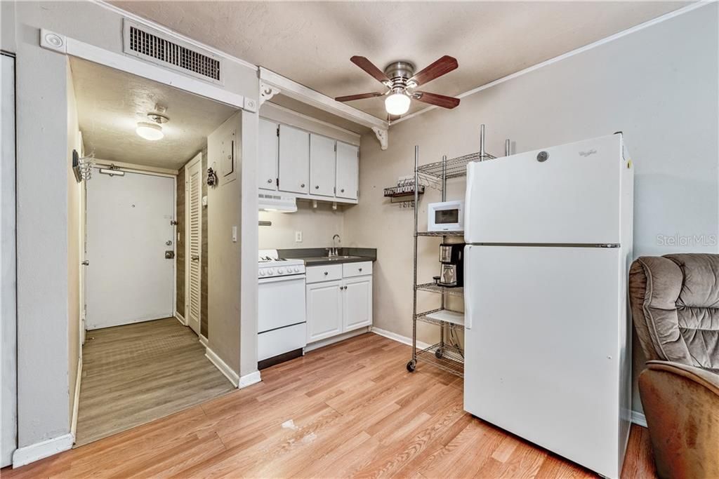 A cozy Kitchen with plenty of cabinet storage and matching appliances is perfect for preparing quick and easy meals.