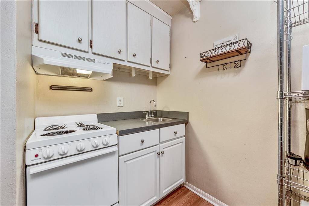 A cozy Kitchen with plenty of cabinet storage and matching appliances is perfect for preparing quick and easy meals.