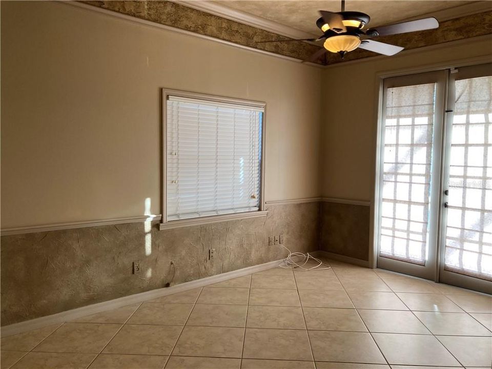 DOWNSTAIRS OFFICE/DEN STUDY - 20 inch imported Tosca Ivory Porcelain Flooring - French Doors lead out to Pavered Lanai/Pool area.