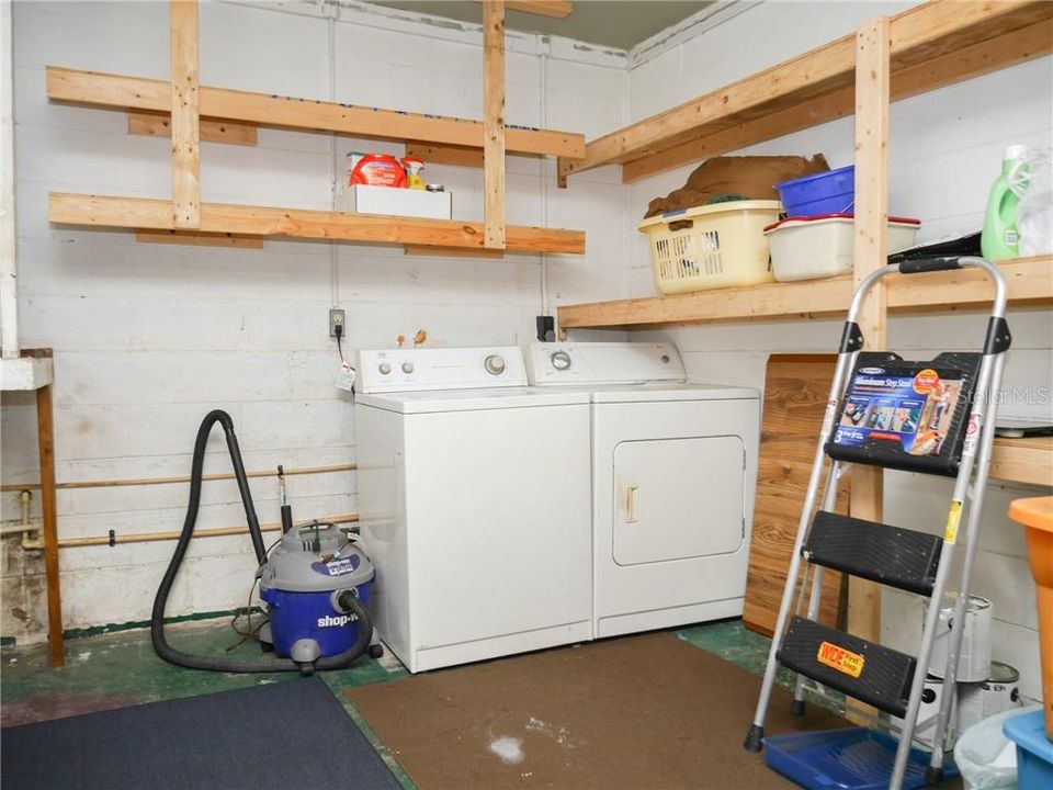 Laundry area and storage shelves.