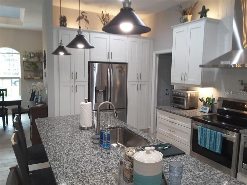 Open kitchen , plenty of counter & cabinet space. Pot filler over range.