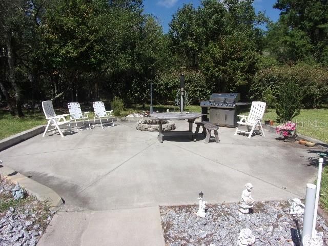 Wonderful poured patio/entertainment area with built-in firepit for enjoying the outdoors at night all year long!