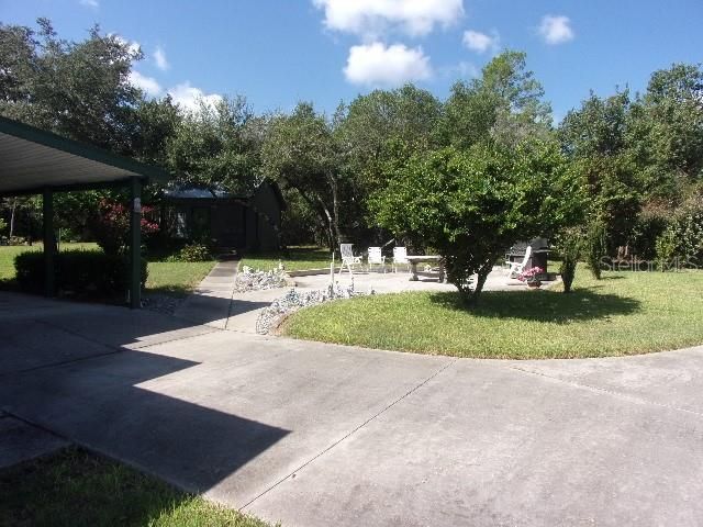 Concrete sidewalks connect home & carport to all other buildings and improvements