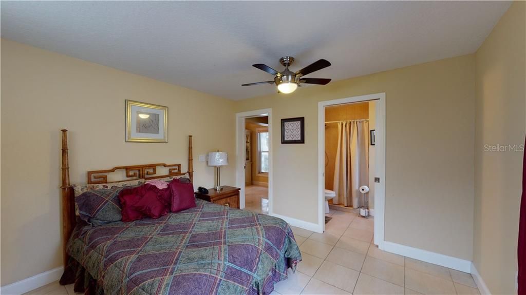 Having a private bath, ceiling fan and natural light make this the perfect guest room.