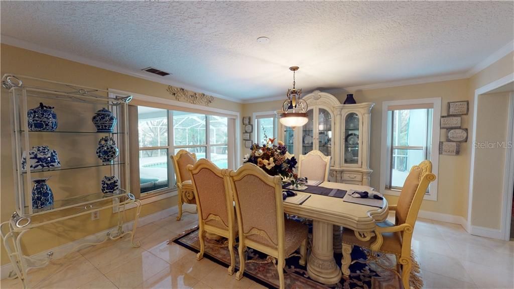 Mable flooring and crown molding make this dining room the perfect place for your family dinners.