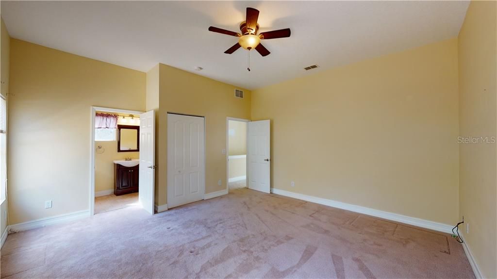 Enormous bedroom with 9' ceilings, ceiling fan, and private bath.