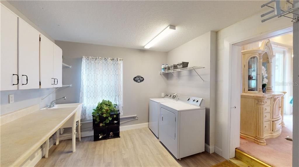 No more lugging laundry upstairs or across the house.  This laundry room is directly off the master suite.