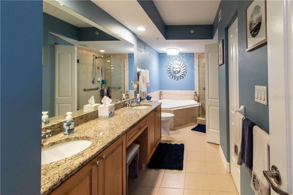 Master bath with dual sinks, jacuzzi tub and separate shower.