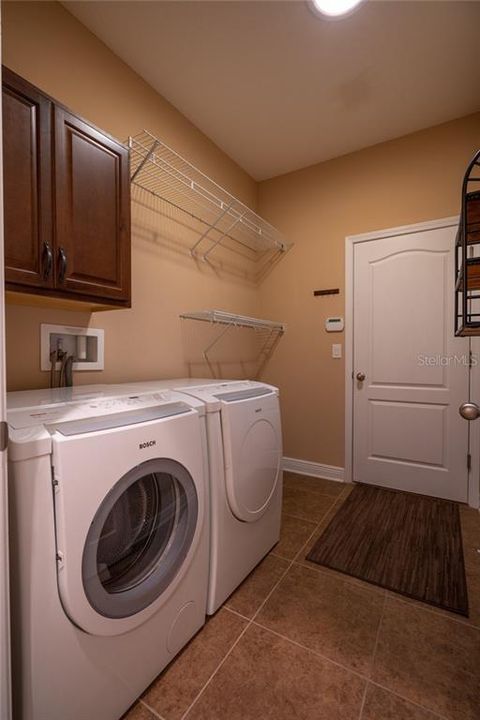 SPACIOUS LAUNDRY ROOM WITH CABINETS & SHELVING