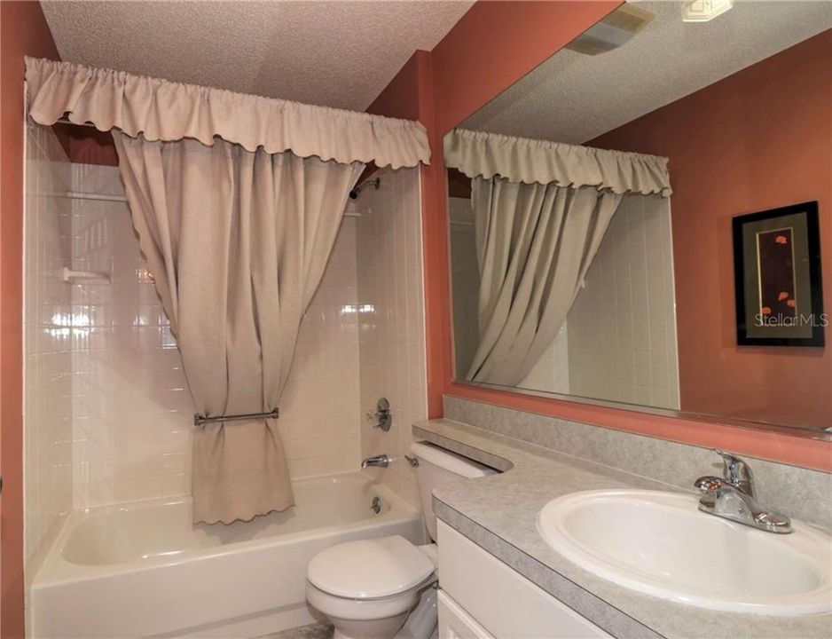 Guest bathroom has tub and shower.