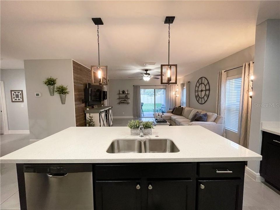 Flat Island kitchen with pendant lighting & quartz countertops and seating for 4